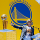 Jun 19, 2015; Oakland, CA, USA; Co-executive chairman and CEO Joe Lacob points towards the Larry O'Brien trophy during the Golden State Warriors 2015 championship celebration in downtown Oakland.